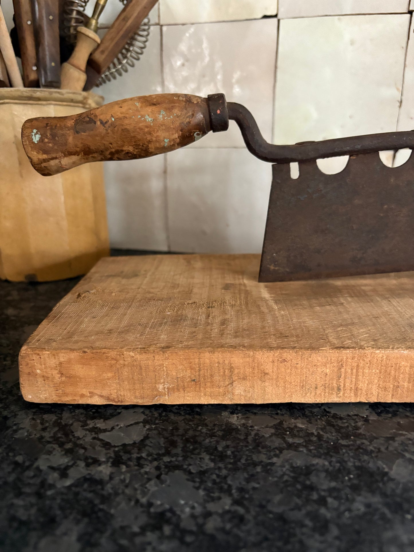 Antique iron & wood herb chopper on cutting board