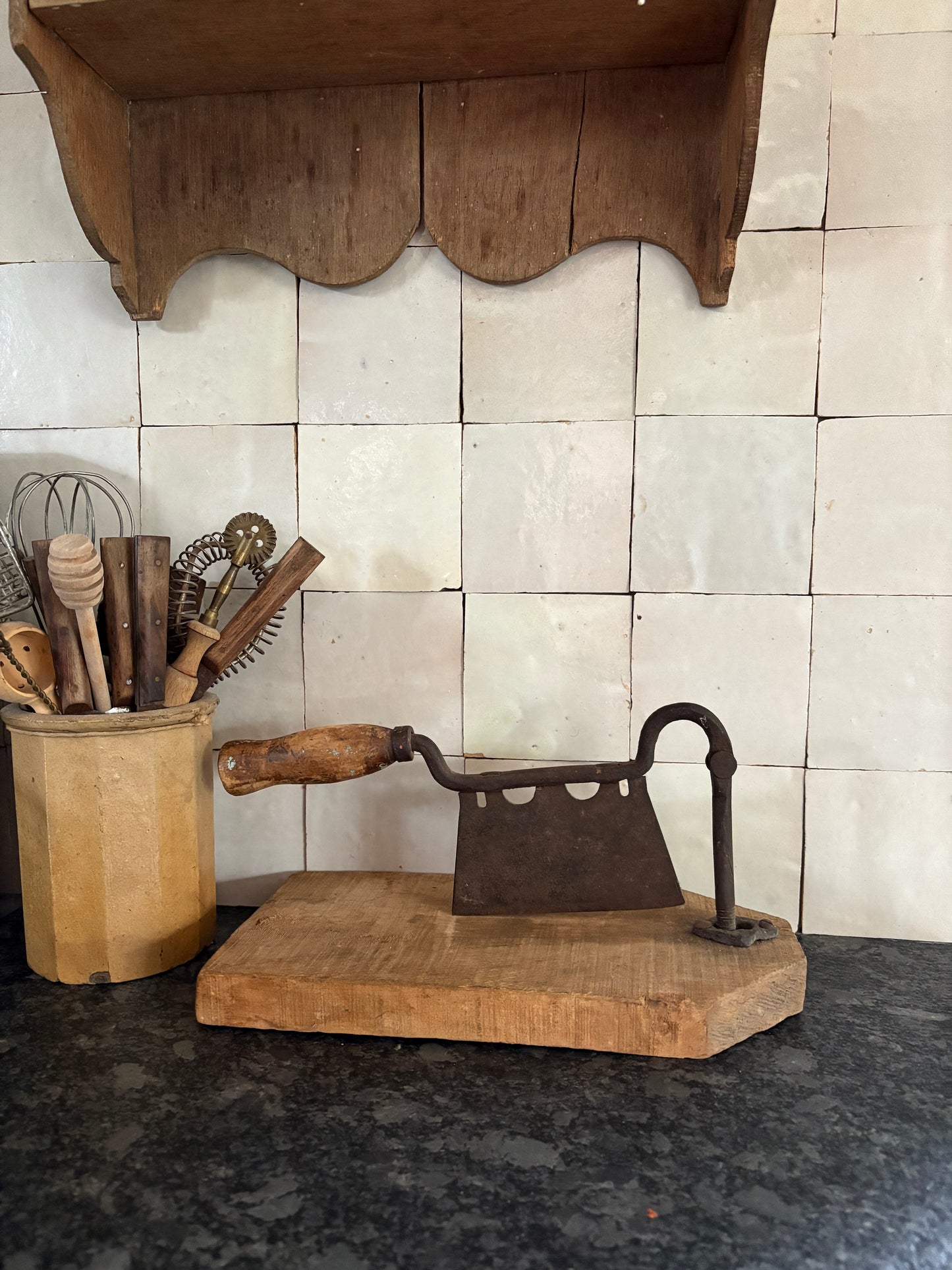 Antique iron & wood herb chopper on cutting board