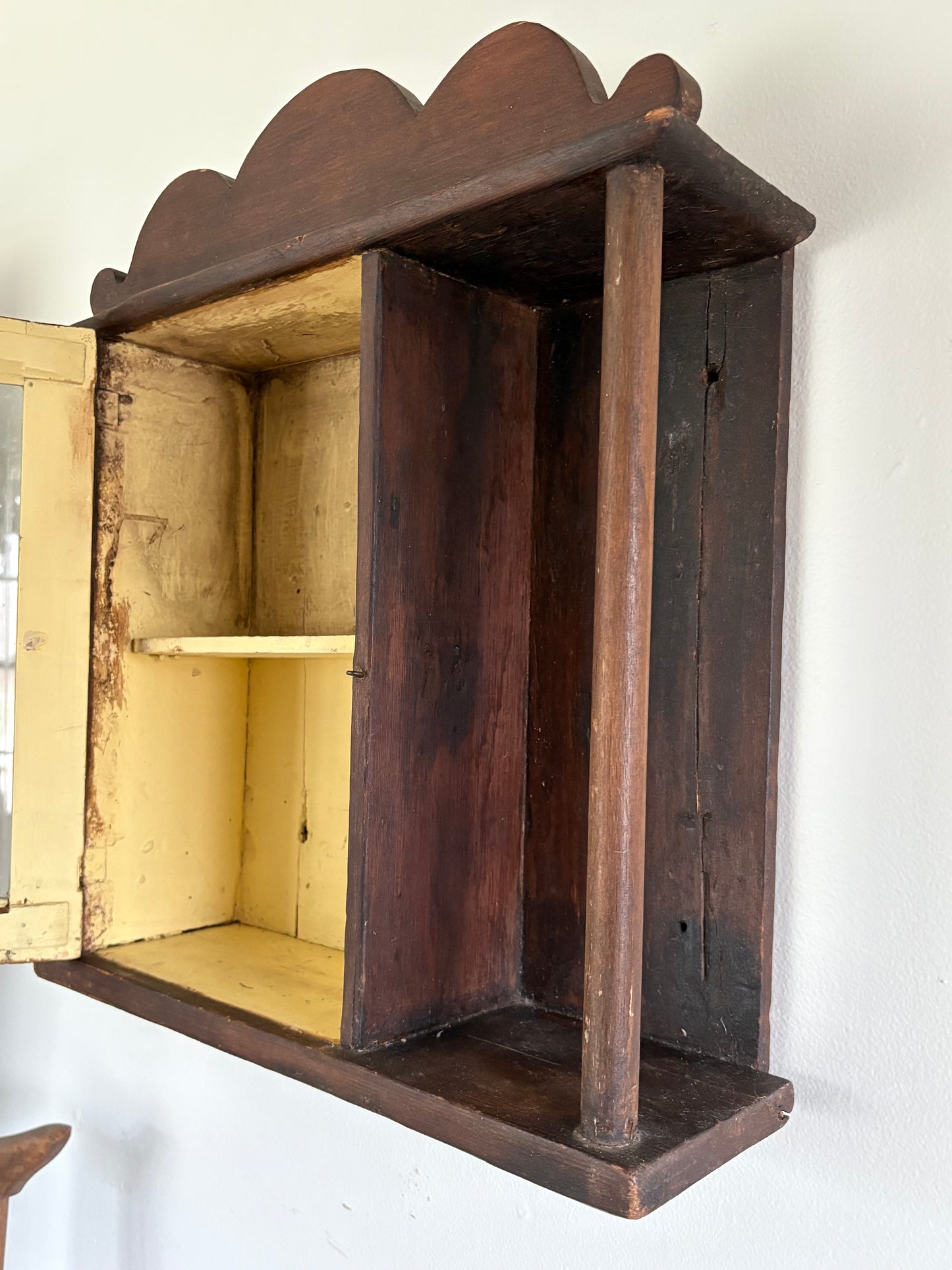 Antique early primitive wall cabinet with scallops