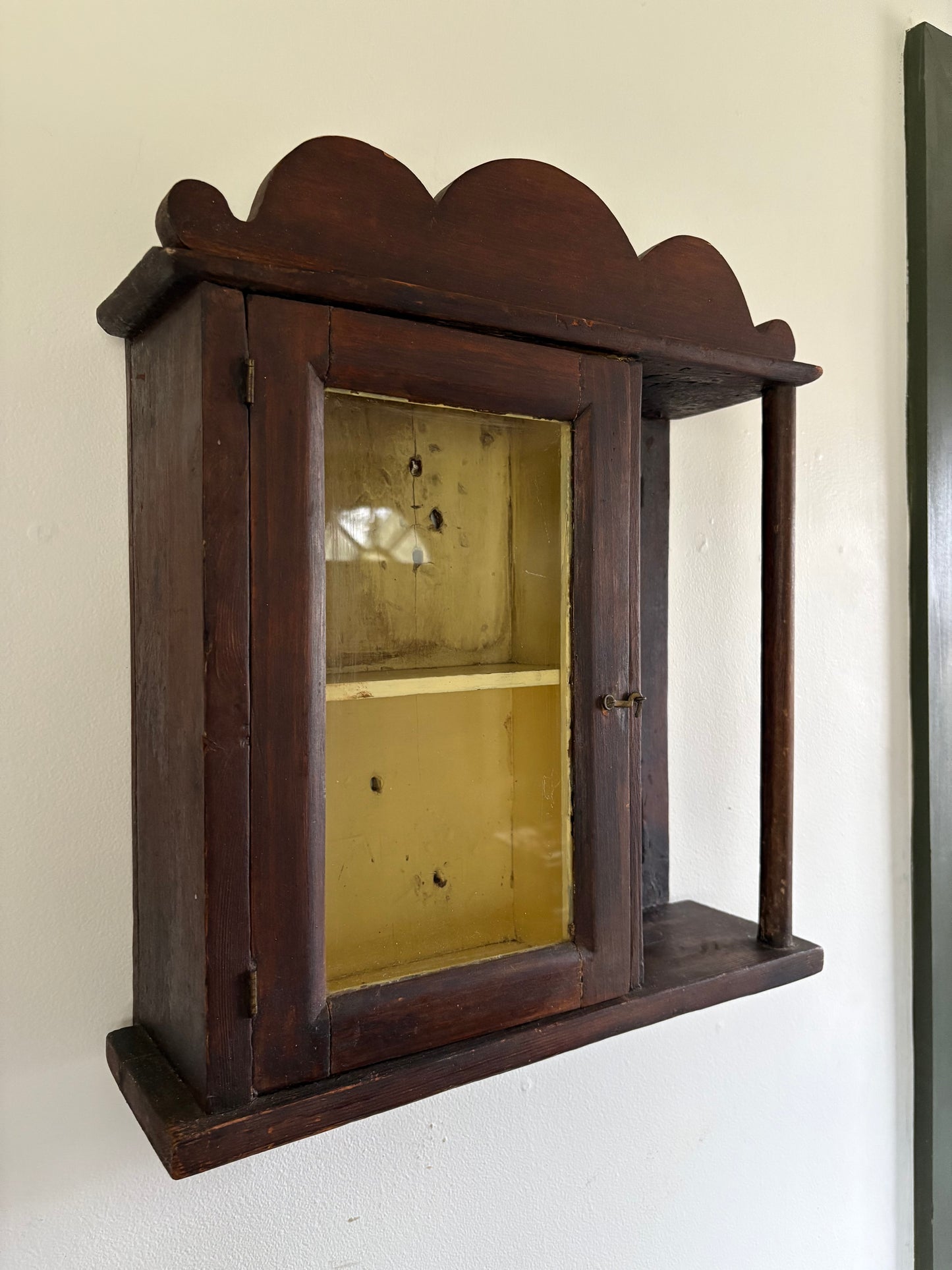 Antique early primitive wall cabinet with scallops