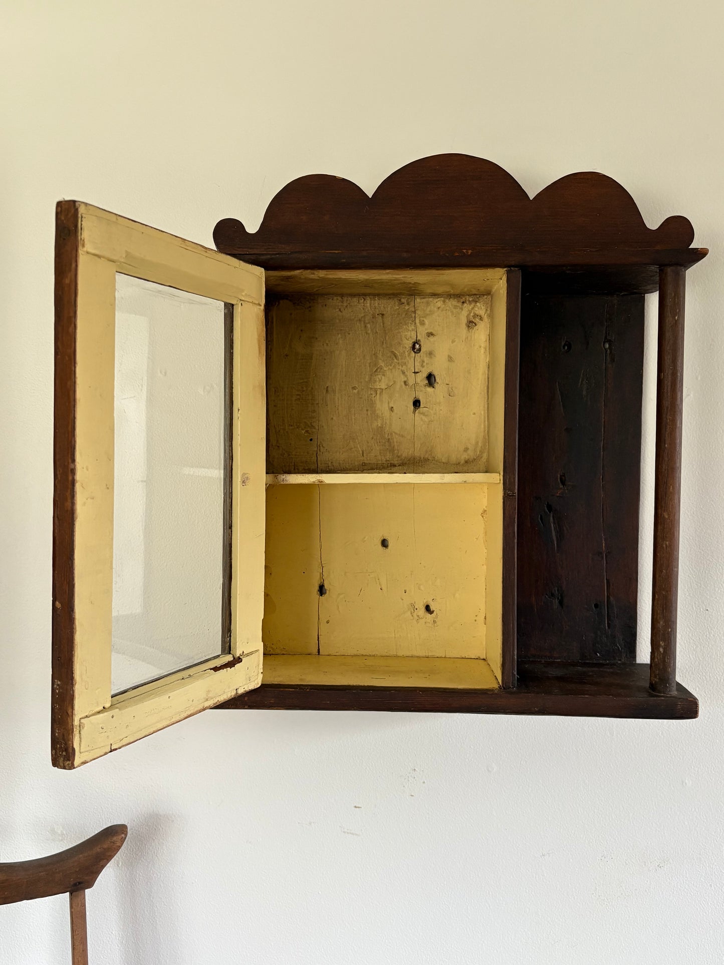 Antique early primitive wall cabinet with scallops