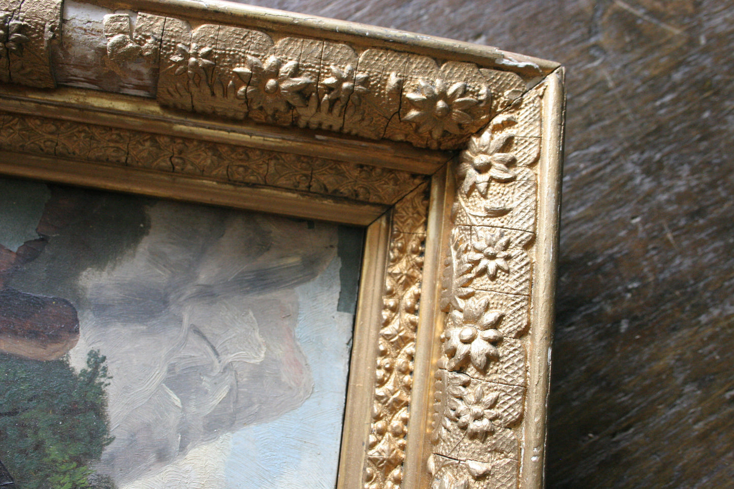 Antique landscape oil painting on board in gilded floral frame