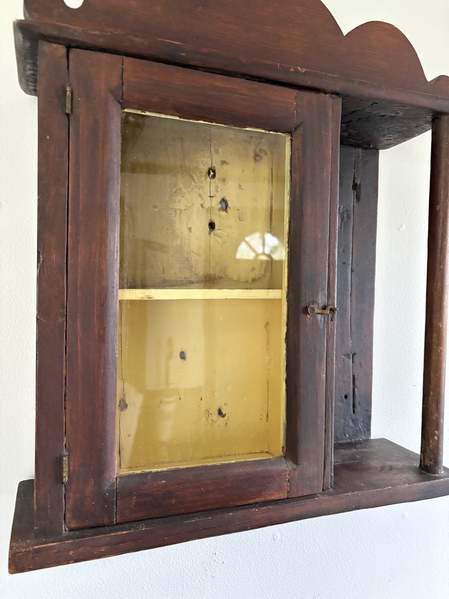 Antique early primitive wall cabinet with scallops