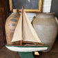Vintage green wooden sailboat