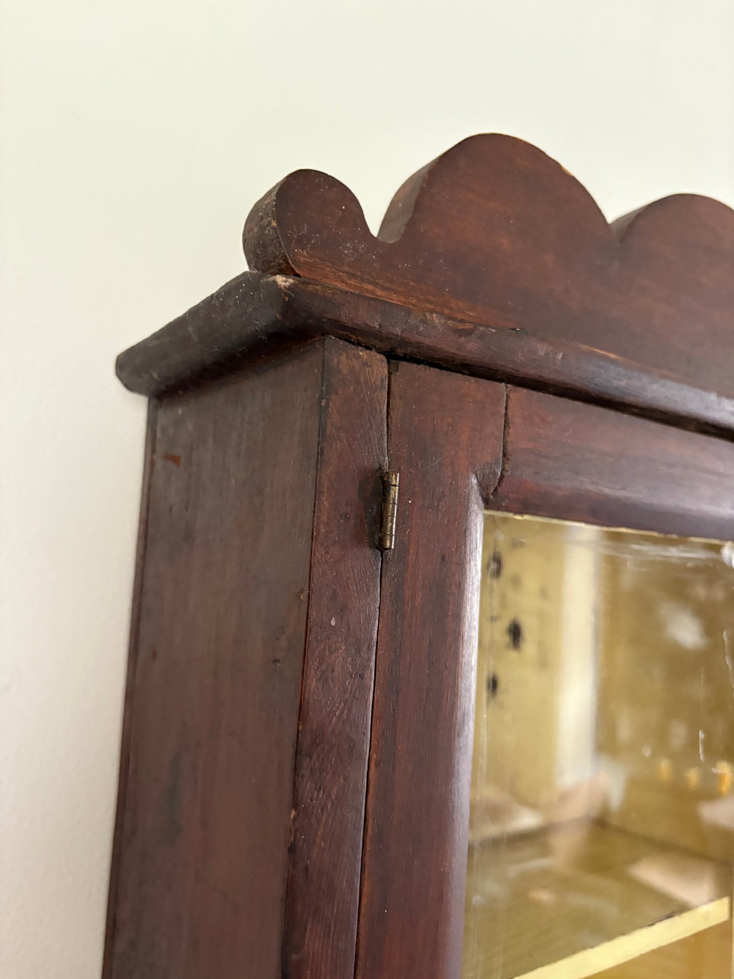 Antique early primitive wall cabinet with scallops