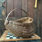 Antique primitive buttocks gathering basket