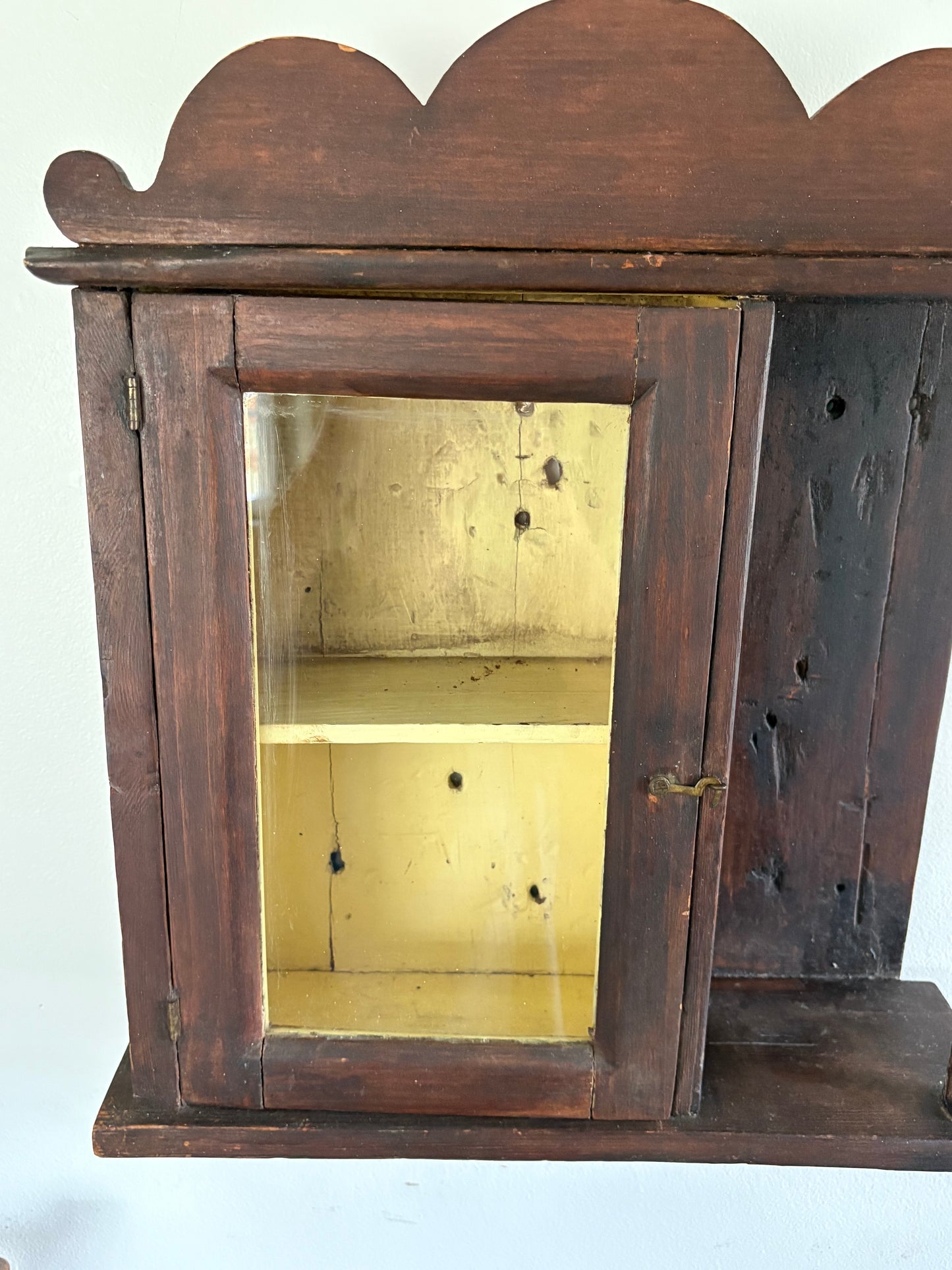 Antique early primitive wall cabinet with scallops