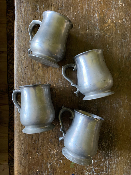 Colonial pewter tankard set of four