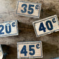 Vintage cardboard price tags on metal stand | general store