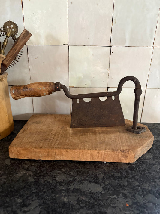 Antique iron & wood herb chopper on cutting board